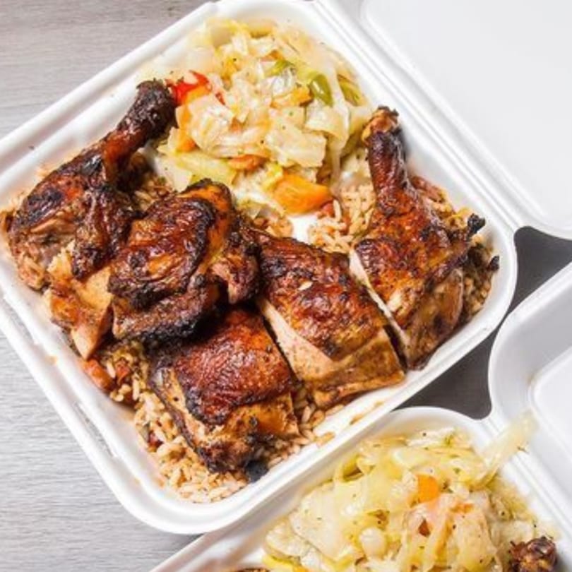 Dixon's Jamaican Taste jerk chicken with rice and peas, and steamed cabbage in a takeout container.